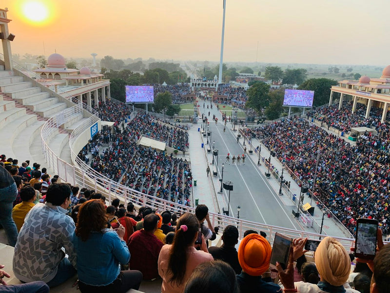 Crowds in the stands watching the flag ceremony at the Attari-Wagah border at sunset
