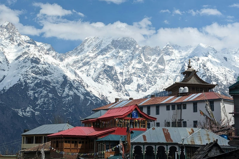 A red-roofed temple in Kalpa with the snow-covered Kinner Kailash range behind it
