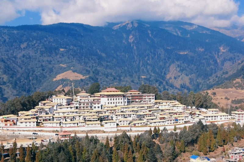 Tawang Monastery, white buildings with yellow roofs on a ridge